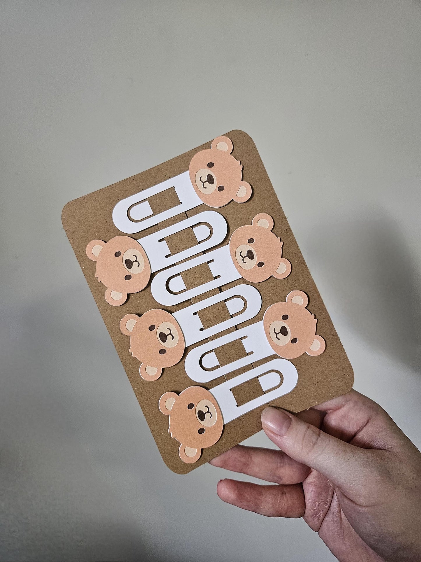 zoomed out full display of brown bear cardstock clip bookmarks clipped onto display pack