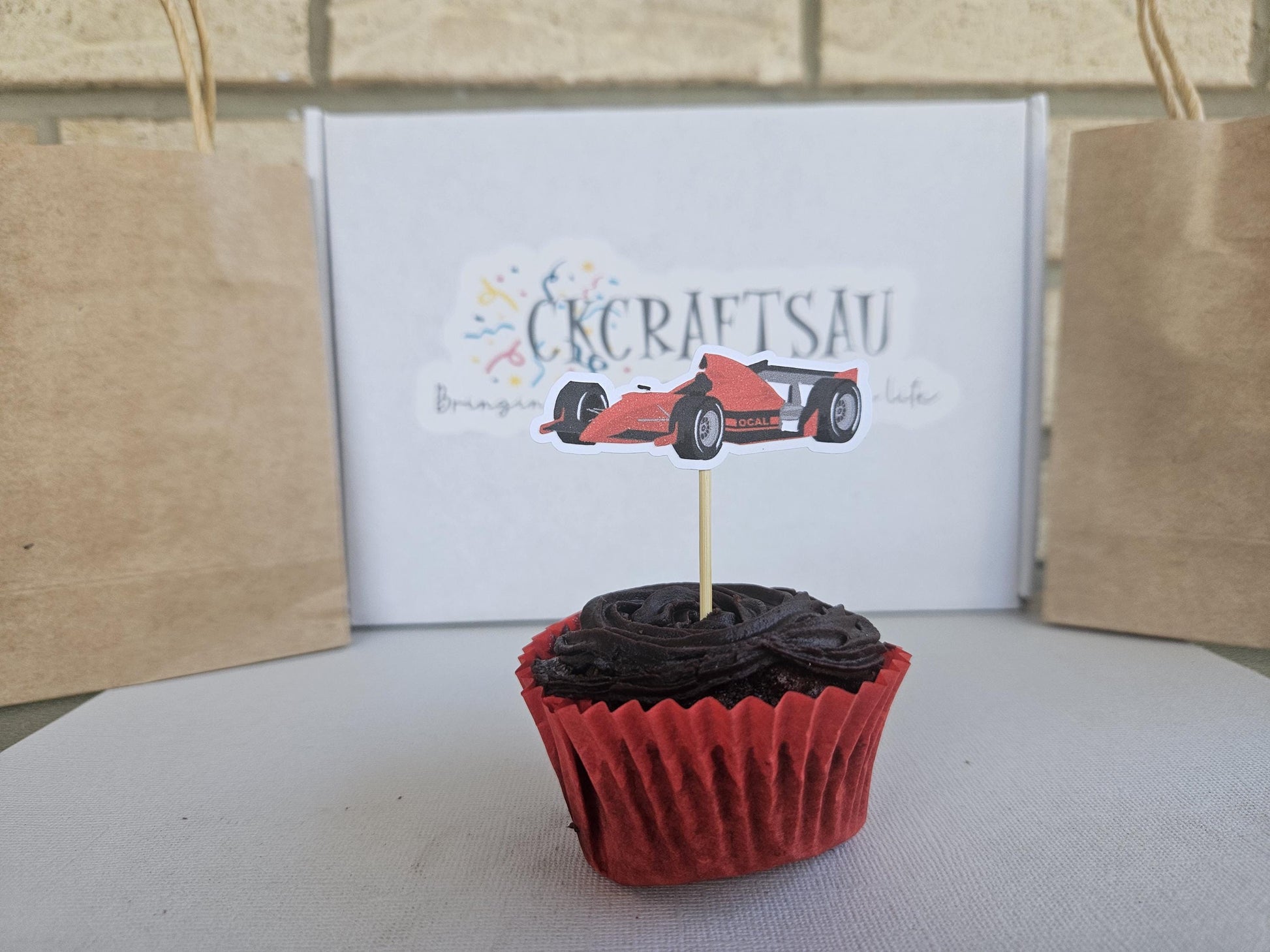 race car cupcake topper displayed on cupcake