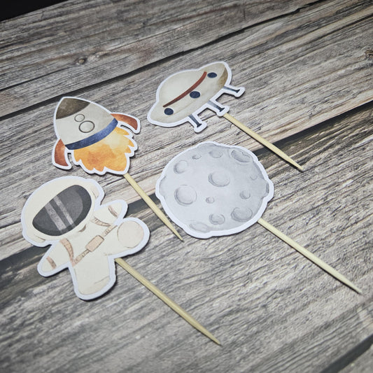 Space cupcake toppers on vinyl background. astronaut, meator, ufo and rocket ship